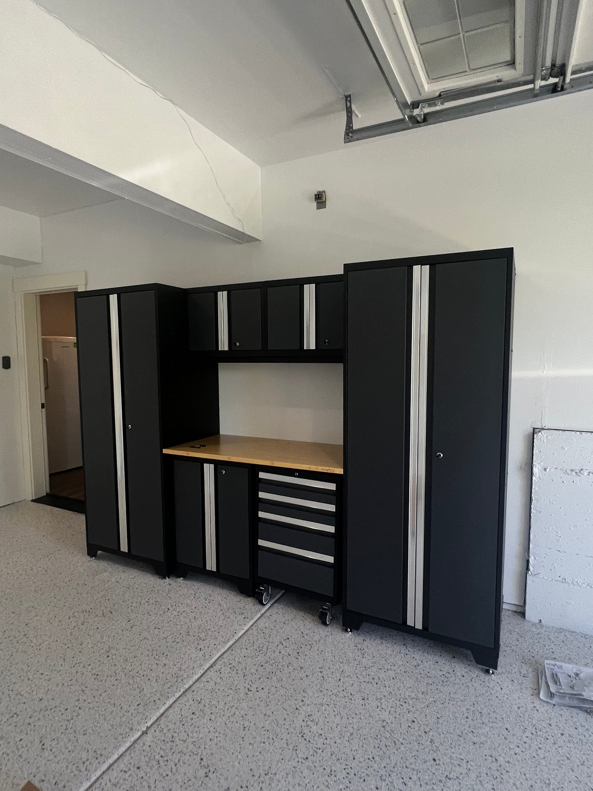 Black steel garage cabinet system with bamboo worktop, installed in a Seattle-area garage