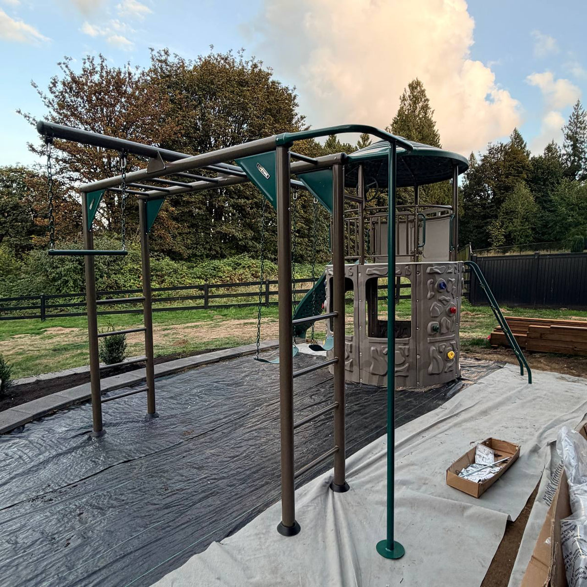 Adventure Tower Deluxe climbing ladder, rock wall, and swing beam after professional assembly