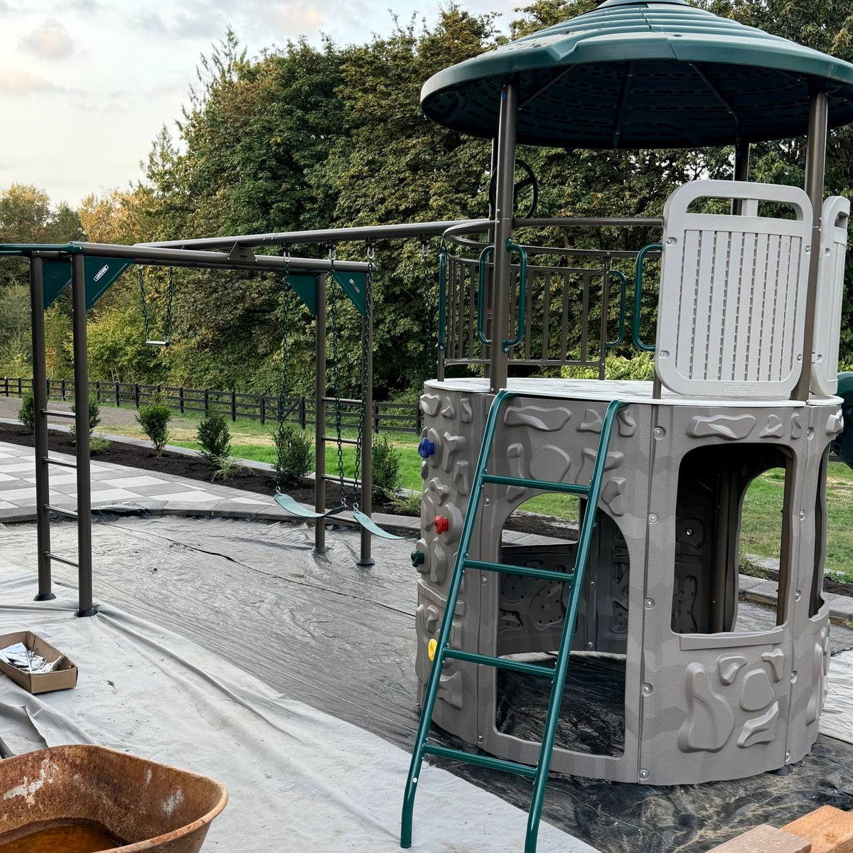 Metal swing set and monkey bars installed beside the Adventure Tower Deluxe play structure