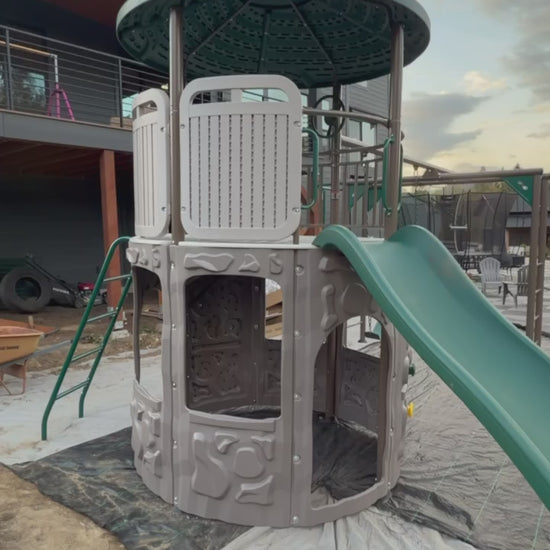 Metal swing set and monkey bars installed beside the Adventure Tower Deluxe play structure