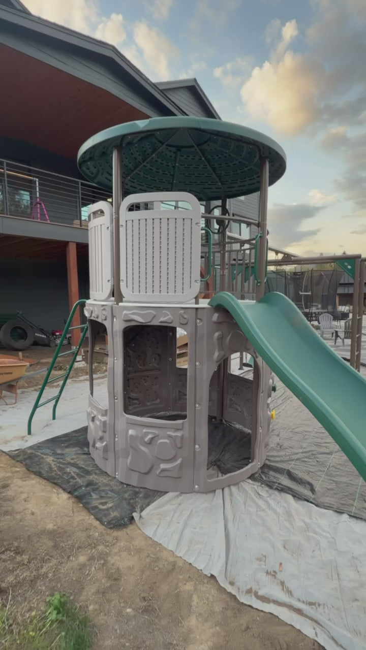 Metal swing set and monkey bars installed beside the Adventure Tower Deluxe play structure